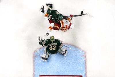 Potential Olympics attendee Martin Pospisil sent flying as he collides with a Minnesota Wild defender.